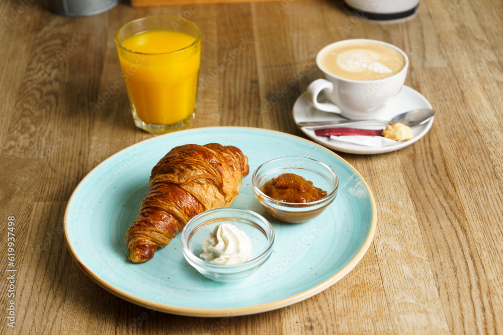 Croissant with butter, home made jam, fresh orange juice and coffee