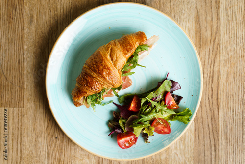 Top down view of Croissant with ham, vegetables and cheese