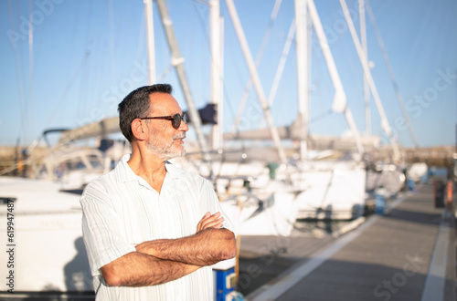 Senior Gentleman Posing With Boats In Yacht Park, Copy Space