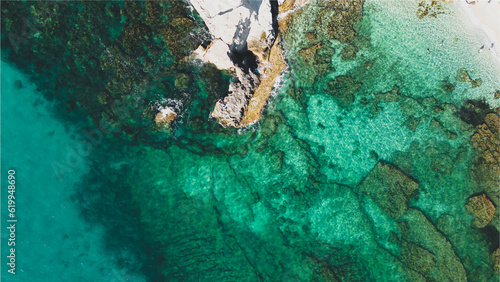 Italy, July 2023: aerial view from the drone of the caribbean sea with colors ranging from turquoise to light blue at the Baia di Riaci near Tropea in Calabria