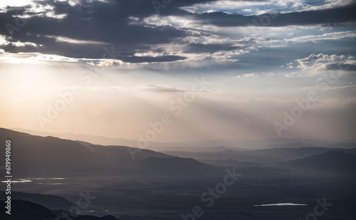 Scenic view from the slopes of the mountain at sunset in the evening with low clouds  evening nature panorama