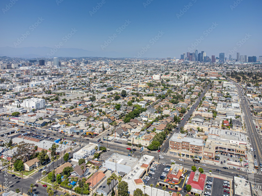 Los Angeles, California - June 29, 2023: Aerial drone photo around LA Koreatown near Western Ave and Pico Blvd with homes, houses with LA Downtown and LA Koreatown buildings