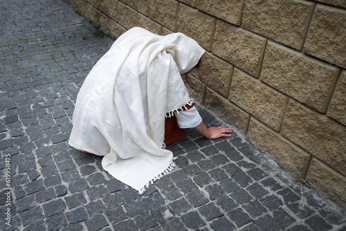 Photography A girl in poor clothes sits on the ground