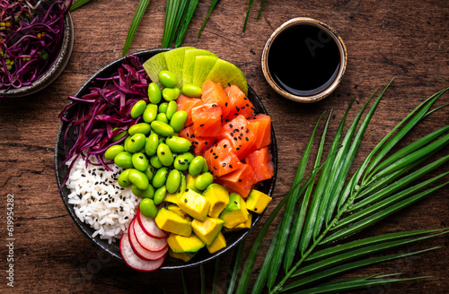 фотографія Hawaiian poke bowl with salmon, avocado, radish, edamame beans, red cabbage and white rice