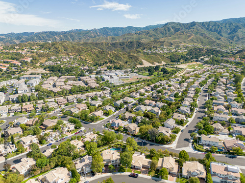 Stevenson Ranch, California - July 3, 2023: Aerial drone photo above Stevenson Ranch City near Santa Clarita, Valencia, CA for homes, houses, condos, and apartments, with a mountain view