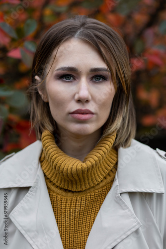 Outdoor atmospheric lifestyle autumn portrait of a beautiful young woman. Cozy atmopshere, fall vibe. Close up