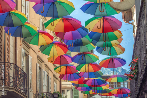 Rainbow umbrellas on blue sky background. Many colorful umbrellas  street decoration for festivals. Concept diversity