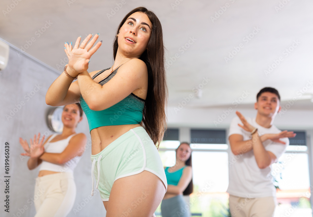 Young boys and girls performing contemporary dance in studio