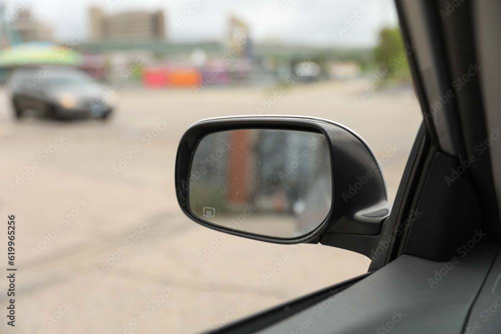 car mirror reflects both practicality and introspection, symbolizing self-reflection, awareness, and the ability to navigate life's paths with foresight