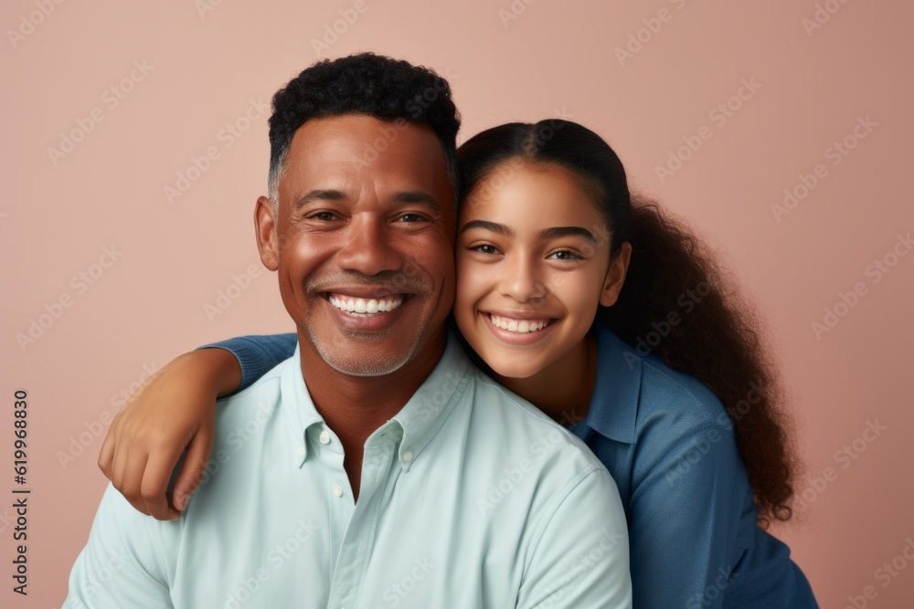 Portrait of happy african american father and daughter embracing on pink background. Ai generated. Portrait of happy african american father and daughter embracing on pink background. Ai generated.