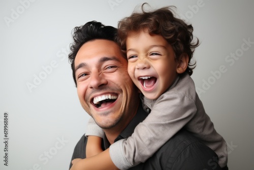 Happy father with his son on grey background. Father's day celebration. Ai generated.