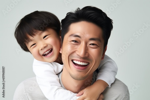 Portrait of a happy asian father and son isolated on white background. Ai generated.