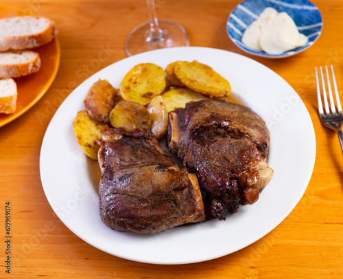 Tasty portion of roasted pork with potatoes served beautifully on plate