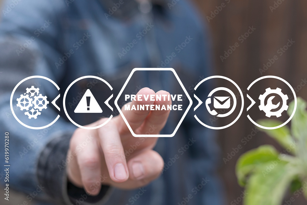 Man working on virtual touch screen of future presses inscription: PREVENTIVE MAINTENANCE. Preventive maintenance business industry concept.