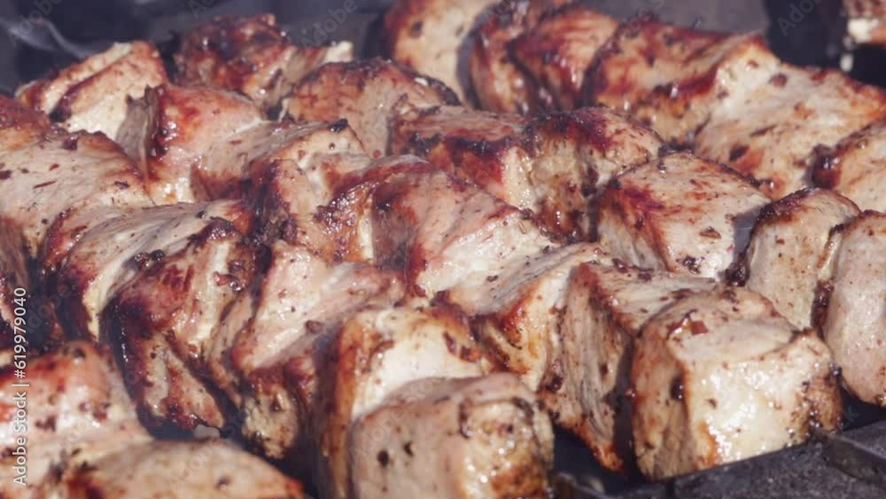 Pork shashlik on steel skewers. Pork pieces close-up. Cooking grilled meat on a charcoal grill. Delicious traditional Caucasian meat dish Pork shashlik on steel skewers. Pork pieces close-up. Cooking grilled meat on a charcoal grill. Delicious traditional Caucasian meat dish
