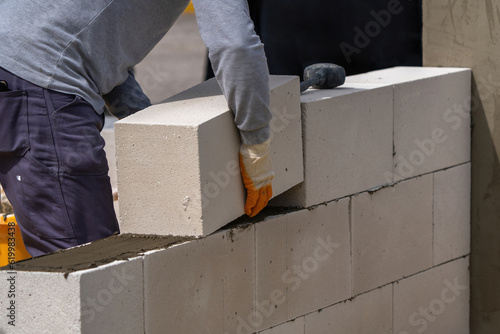 The bricklayer is working. Building a wall of aerated concrete. Gasbeton wall photo