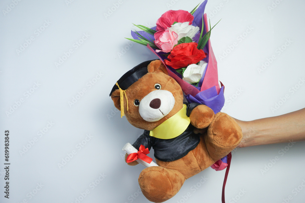 Naklejka premium holding and giving teddy bears and flowers on graduation day