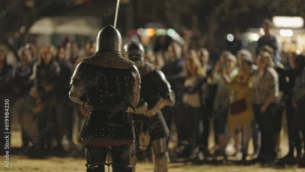 Show of medieval gladiatorial fights on the street surrounded by people