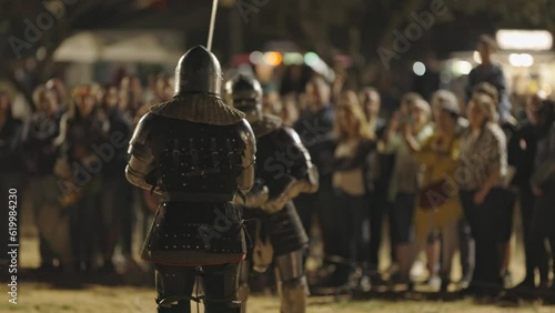 Show of medieval gladiatorial fights on the street surrounded by people