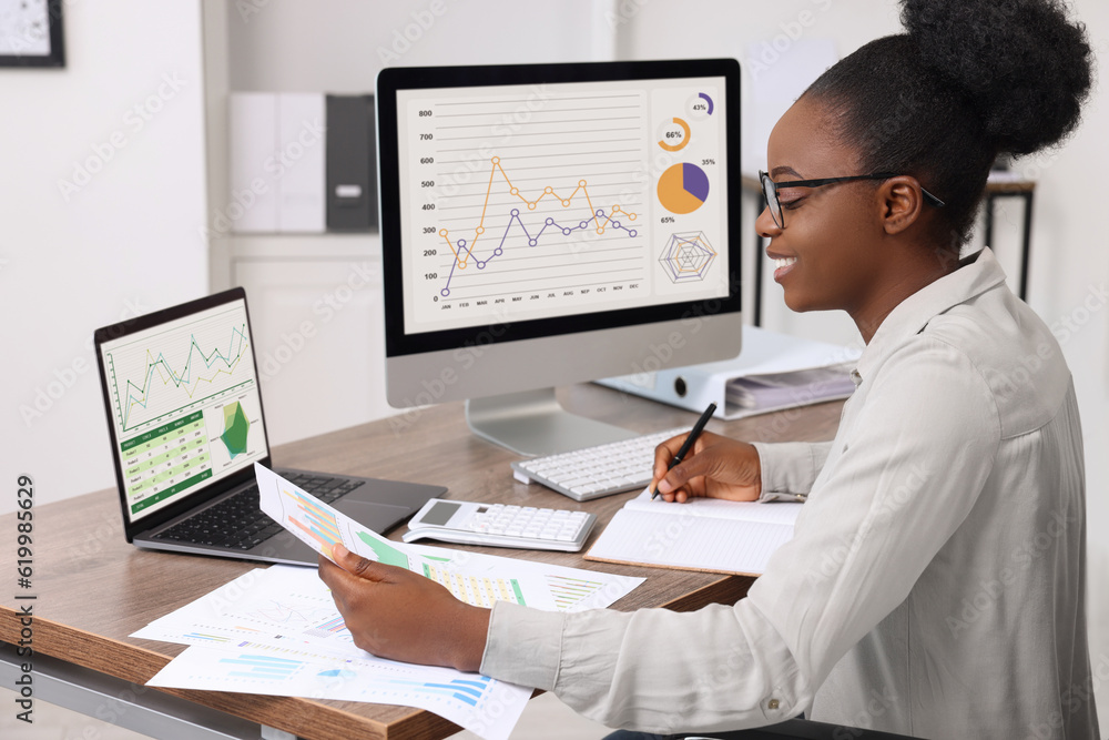 Professional accountant working at wooden desk in office Professional accountant working at wooden desk in office