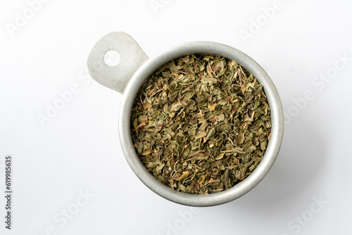 Dried Peppermint Flakes Herb in a Measuring Cup