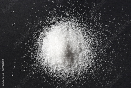 pile of sea salt on black background	