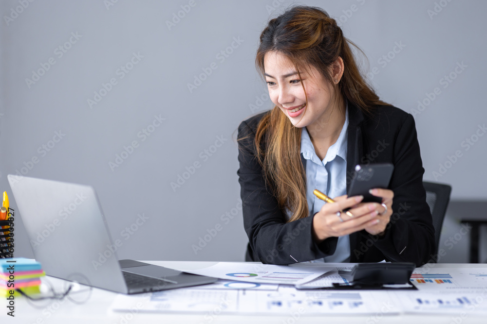 Thoughtful young asian woman entrepreneur holding smart phone and checking financial reports business plan investment, finance analysis concept Thoughtful young asian woman entrepreneur holding smart phone and checking financial reports business plan investment, finance analysis concept
