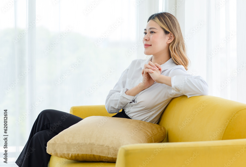 Asian professional successful cheerful happy thoughtful female businesswoman entrepreneur in formal outfit sitting alone on cozy sofa couch thinking business ideas solving problems in living room Asian professional successful cheerful happy thoughtful female businesswoman entrepreneur in formal outfit sitting alone on cozy sofa couch thinking business ideas solving problems in living room
