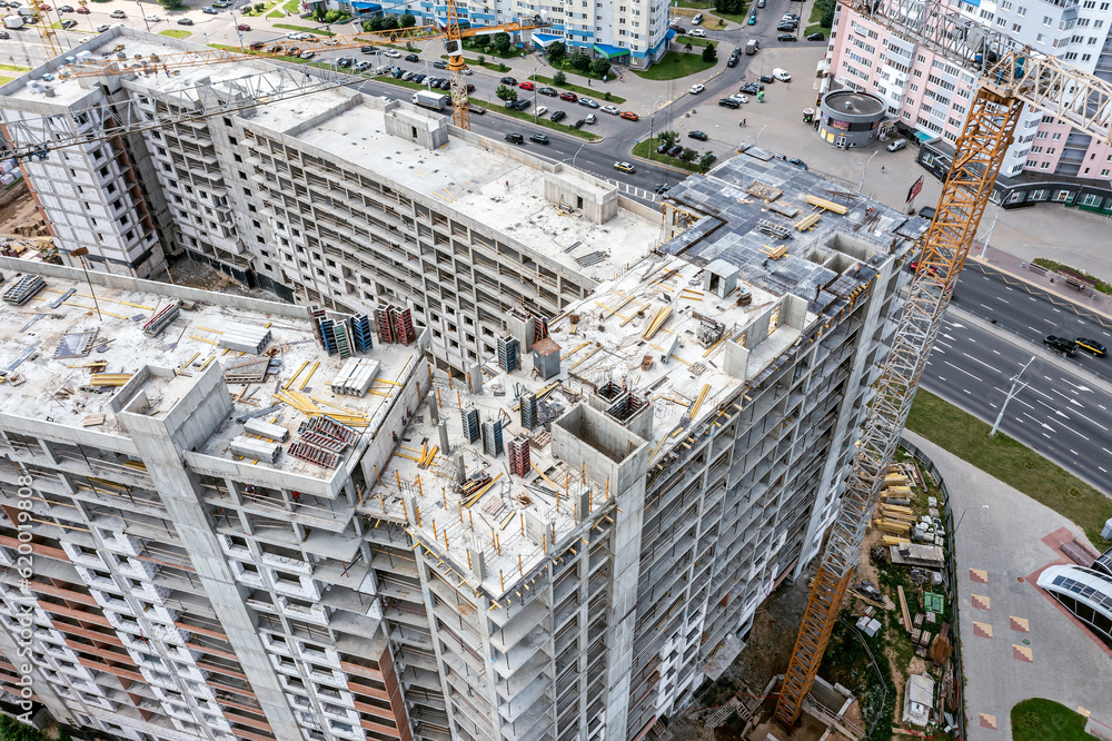 construction of new high-rise apartment building in residential area. aerial overhead view.