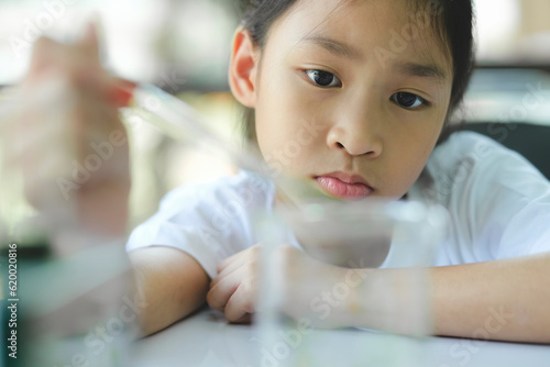 Little child with learning science class in school laboratory