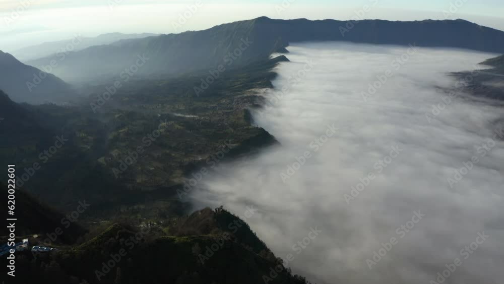 Aerial view of a fog covered valley in the Bromo Tengger Semeru National Park of Java, Indonesia Aerial view of a fog covered valley in the Bromo Tengger Semeru National Park of Java, Indonesia
