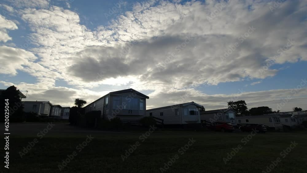 Time lapse sunset clouds changing above Welsh static caravan camp site resort Time lapse sunset clouds changing above Welsh static caravan camp site resort