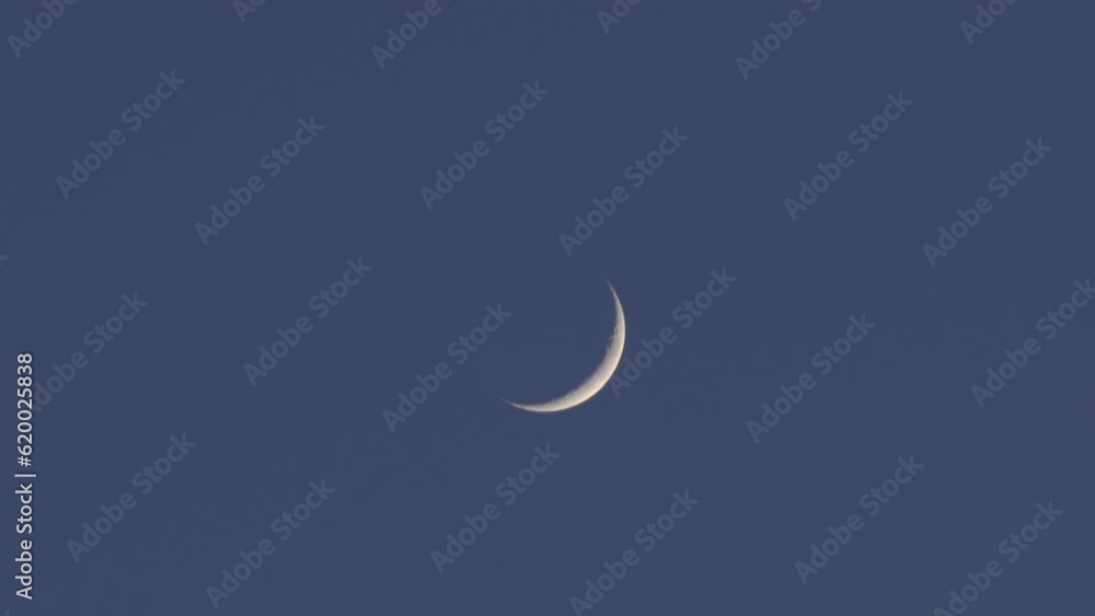 Beautiful waxing crescent moon glowing in dark blue sky at twilight Beautiful waxing crescent moon glowing in dark blue sky at twilight