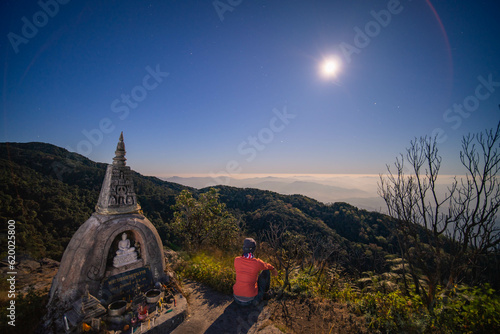 buddha in the summit and the moon and a women (Changmai province, Thailand) photo