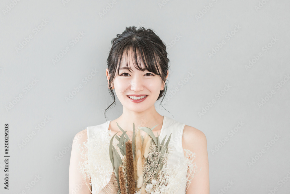 ブーケ・花束を持つアジア人女性（ブライダル・花嫁・結婚）
