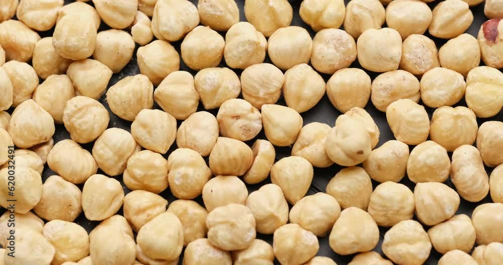 Whole shelled hazelnuts nuts kernels close-up on rotating platform Whole shelled hazelnuts nuts kernels close-up on rotating platform