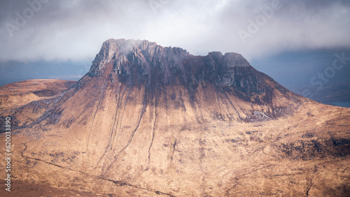 Moody view of Stac Pollaidh mountain in the North West Highlands of Scotland on a cloudy day.