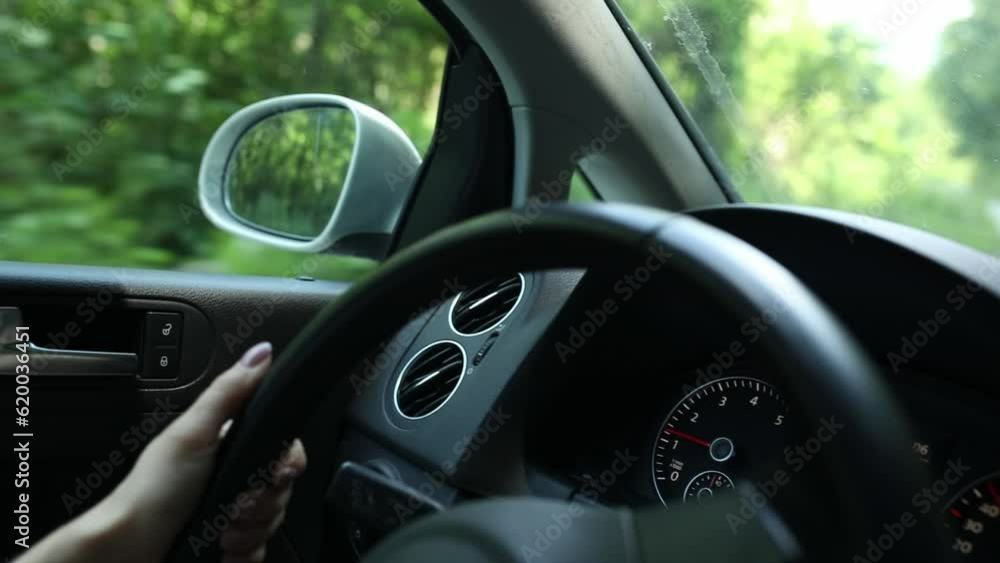 driving a car. female hands turn the steering wheel on turns. High quality FullHD footage driving a car. female hands turn the steering wheel on turns. High quality FullHD footage