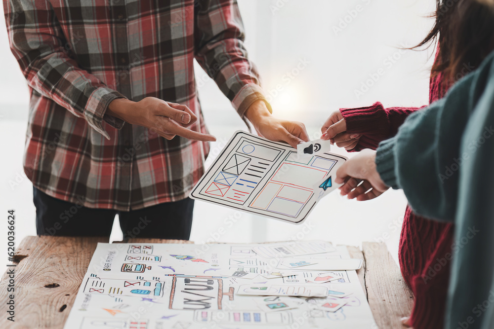 Naklejka premium Close up ux developer and ui designer brainstorming interface wireframe design.Creative digital development agency