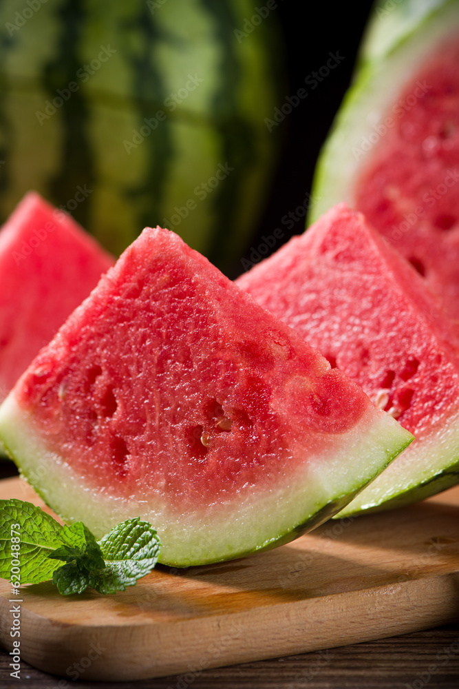 Fresh sliced watermelon on wooden background