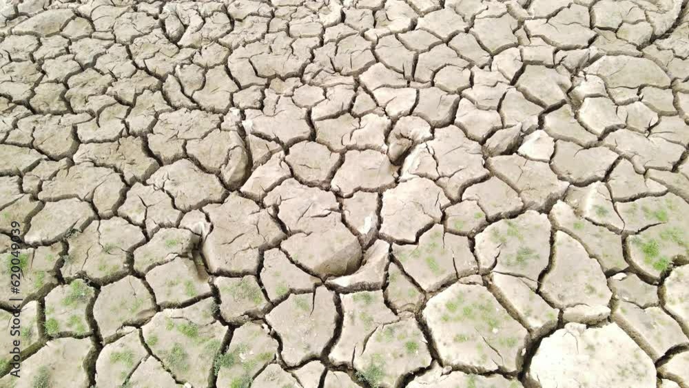 Aerial Shot of an Extremely Dry Soil Crack Pattern on a Dry Riverbed showing the Consequences of Global Warming (UHD) Aerial Shot of an Extremely Dry Soil Crack Pattern on a Dry Riverbed showing the Consequences of Global Warming (UHD)