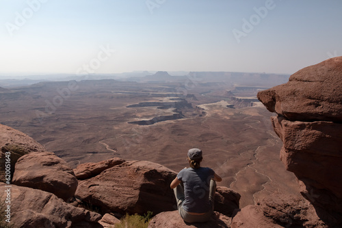 Woman sitting down taking in the view of Canyonlands National Park