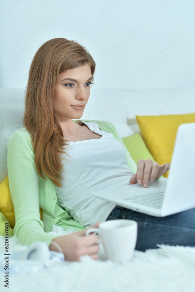 young woman with cup of coffee and laptop young woman with cup of coffee and laptop