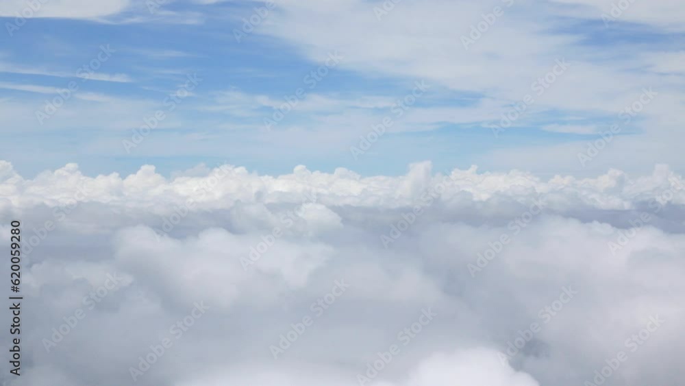 blue sky with white fluffy clouds from airplane flight fly over the clouds in a sunny day with cloud moving in the atmosphere in hot weather summer time. blue sky with white fluffy clouds from airplane flight fly over the clouds in a sunny day with cloud moving in the atmosphere in hot weather summer time.