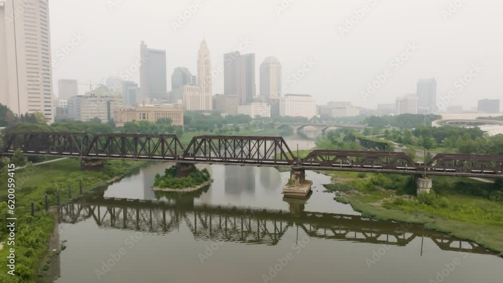 Aerial view of Columbus Ohio skyline with train tracks bridge flyover on a foggy smoky day Aerial view of Columbus Ohio skyline with train tracks bridge flyover on a foggy smoky day