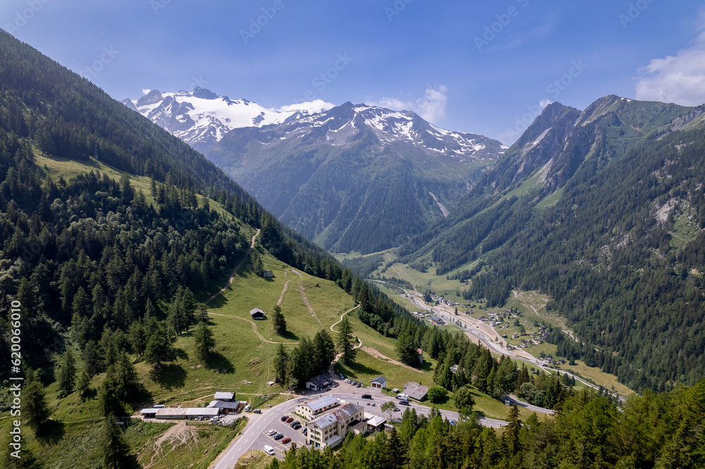 Aerial view of meandering roads vantage viewpoint lookout in mountains of French Alps with Mont Blanc Massive and eternal snow tops in the background. Tourism and outdoor sports ski holidays region.