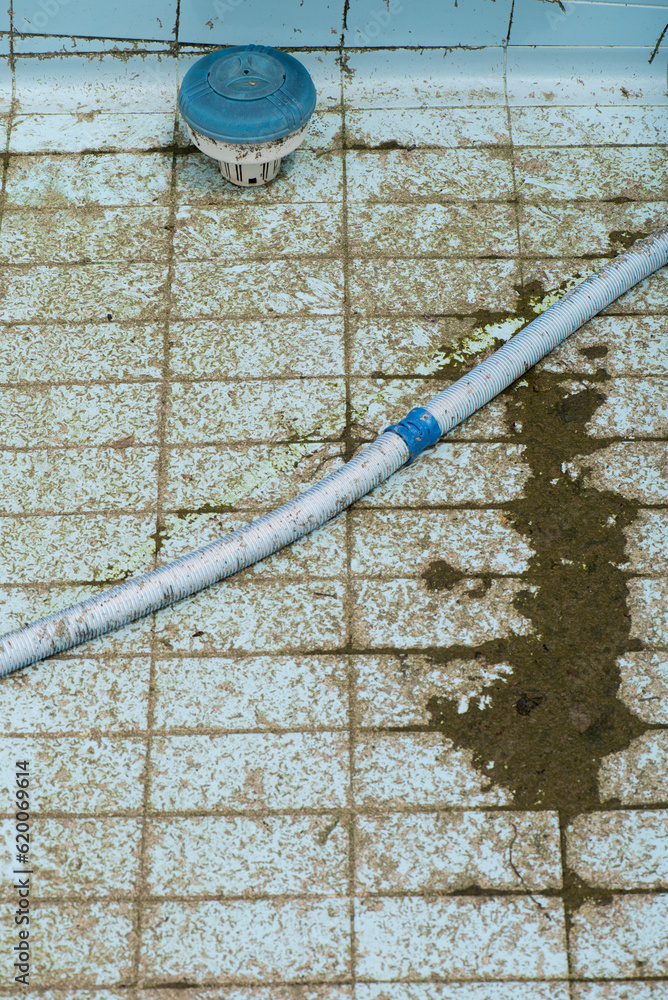detail of pool robot vacuuming dirt from the floor of an empty and