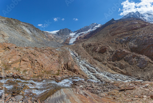 Lunar panorama of rocks crossed by streams and smoothed by the Valleunga glacier. The glacier is in rapid retreat occurred due to global warming, Alto Adige, Italy