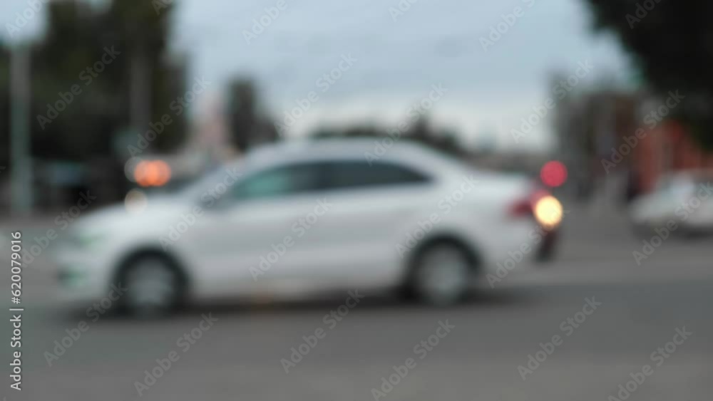 busy street transport interchange in a blur. unfocused cars are racing along the highway of the city highway. bus, trolleybus stops at the intersection. blurry evening drive home from work. busy street transport interchange in a blur. unfocused cars are racing along the highway of the city highway. bus, trolleybus stops at the intersection. blurry evening drive home from work.