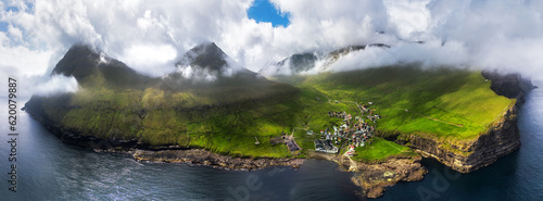 Faroe islands - Aerial panoramic view of the village of gjogv on cliffs washed by the ocean, Eysturoy island,  Denmark, Europe photo